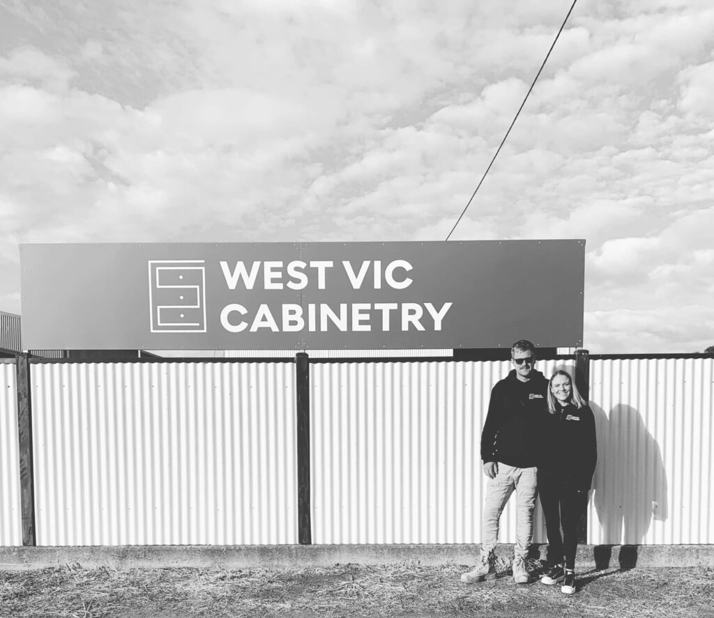 Ben and Jess standing in front of the WEST VIC CABINETRY sign outside their Horsham workshop