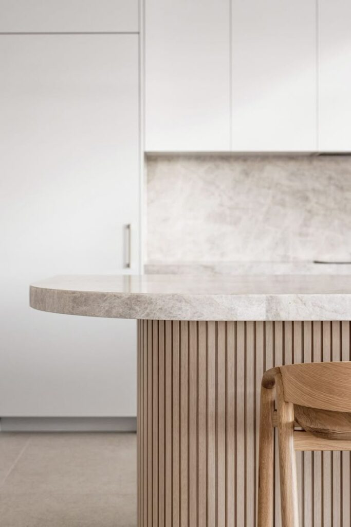 Grey stone kitchen benchtop with timber island panelling in modern design