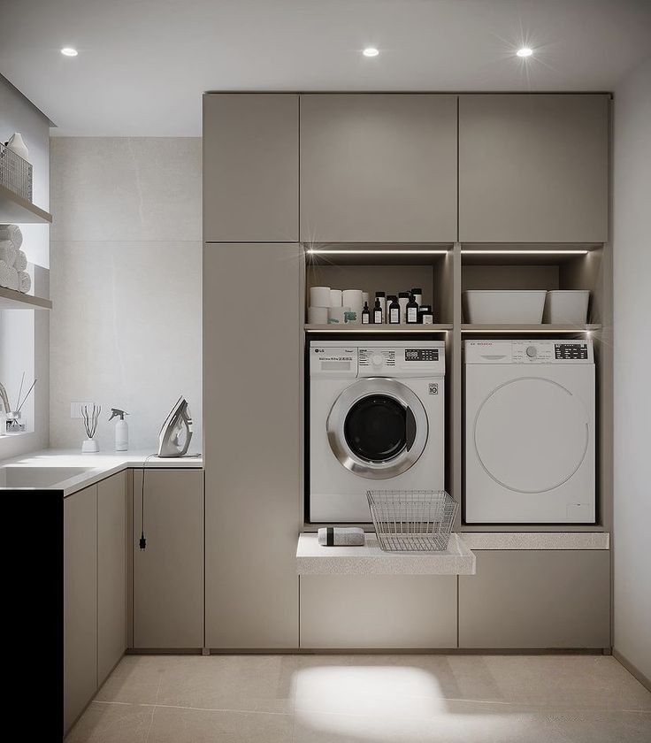 Beige laundry with custom cabinetry and a pull-out panel designed to hold a washing basket