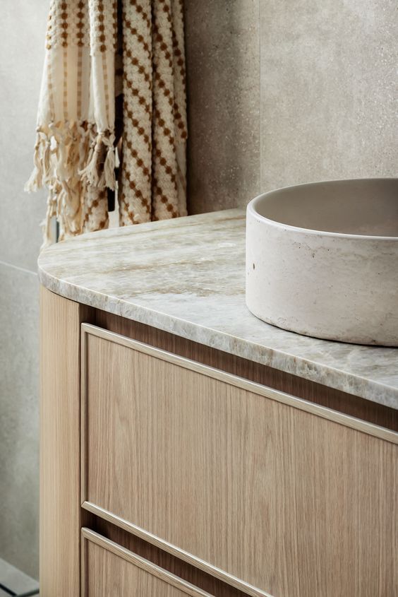 Woodgrain vanity with recessed rail drawers, stone benchtop, and a top-mount basin