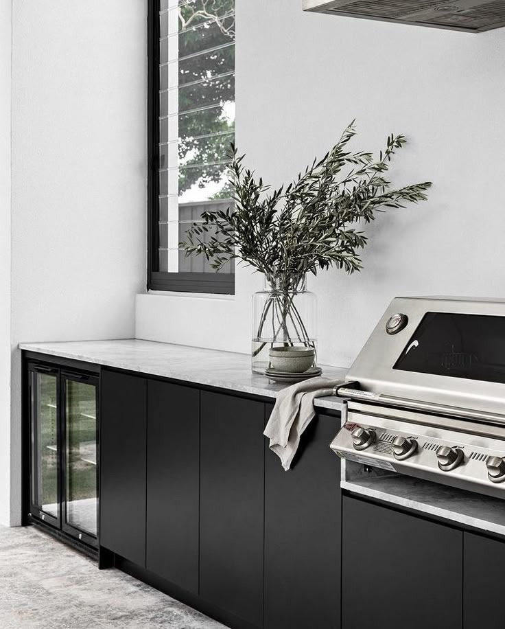 Black Stylex entertaining area featuring sleek cabinetry and a stone benchtop