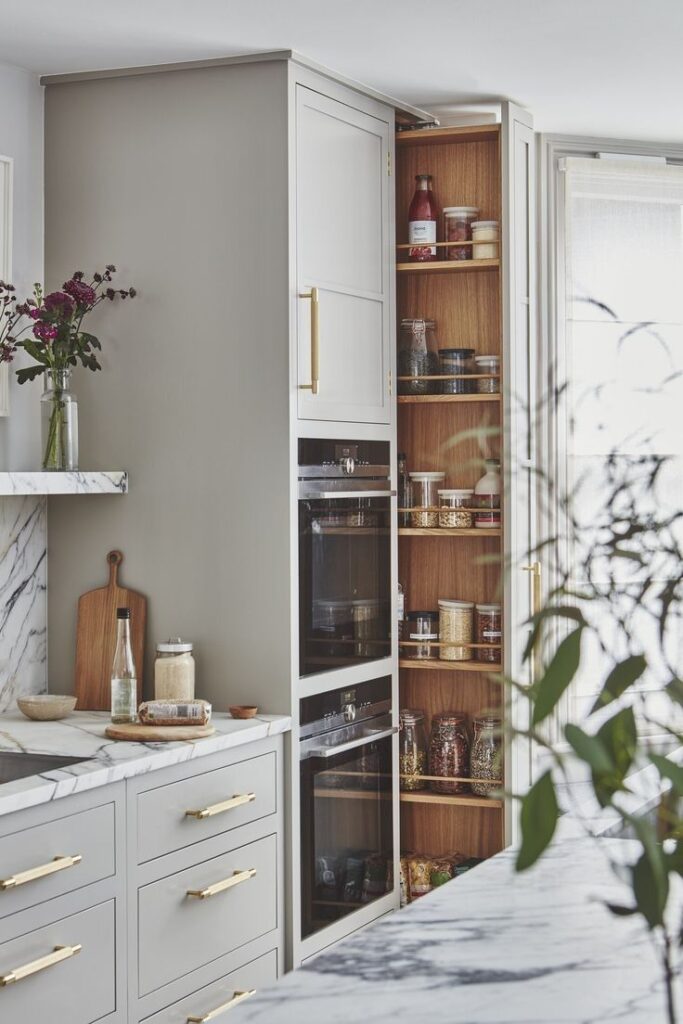 Pull-out vertical pantry with tiered shelving for easy access and organised storage