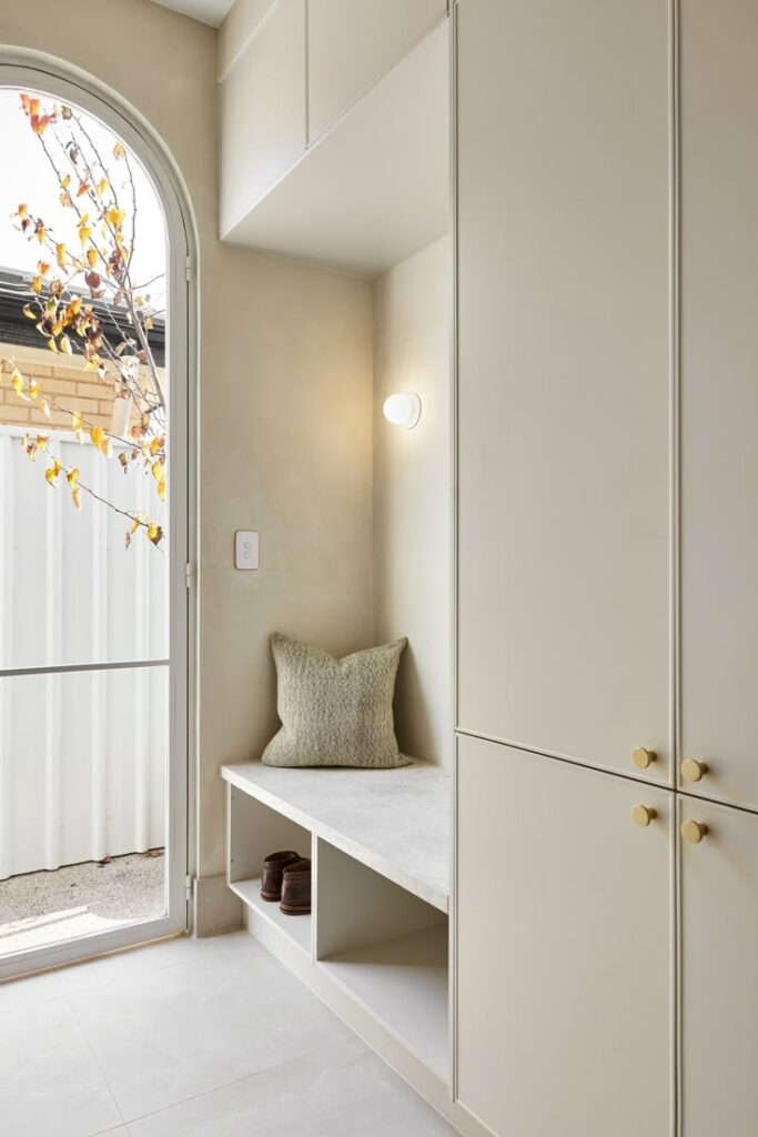 Vinyl-wrapped mudroom with built-in bench seat and overhead storage