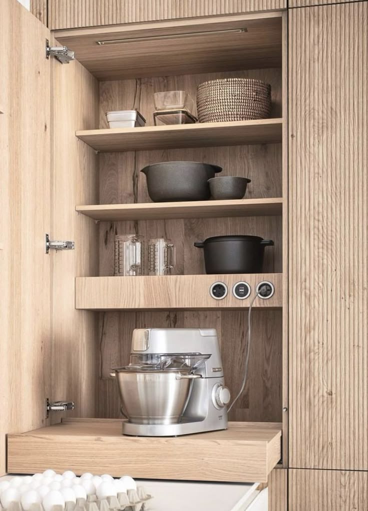 Woodgrain pull-out appliance shelf with built-in power points inside the cabinetry for convenient access