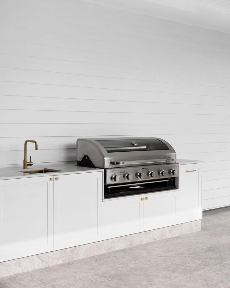 Built-in BBQ with vinyl cabinet doors and a durable stone benchtop