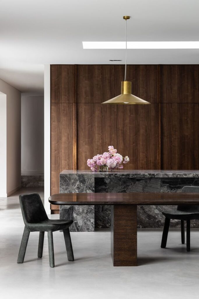 Grey marble statement island with modern walnut cabinetry